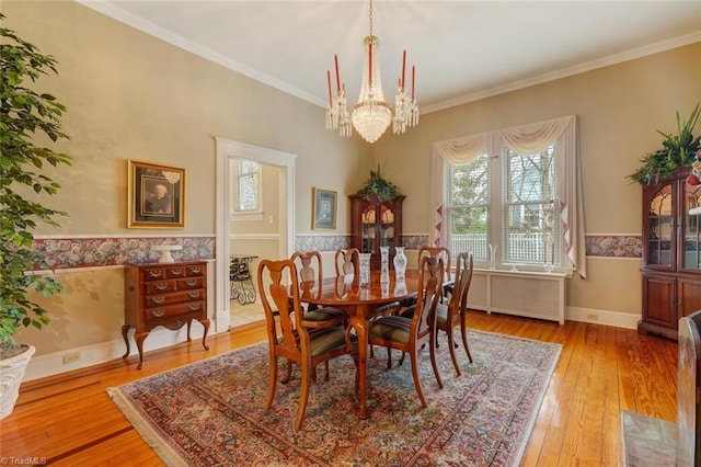 dining room with hardwood / wood-style flooring, plenty of natural light, and ornamental molding