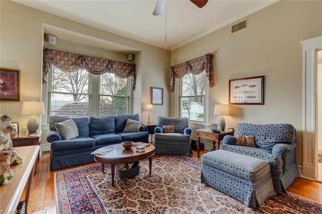 living room featuring hardwood / wood-style flooring, ceiling fan, and ornamental molding