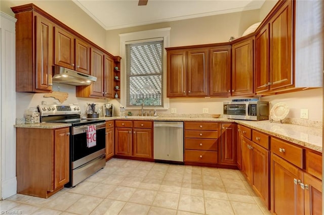 kitchen featuring light stone counters, ornamental molding, sink, and appliances with stainless steel finishes