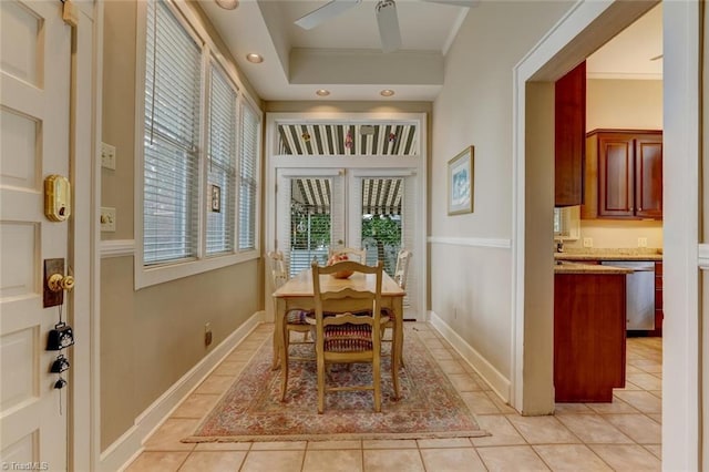 tiled dining space featuring ceiling fan and crown molding