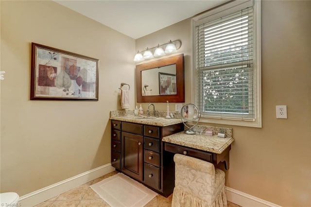 bathroom featuring tile patterned flooring, vanity, and a healthy amount of sunlight