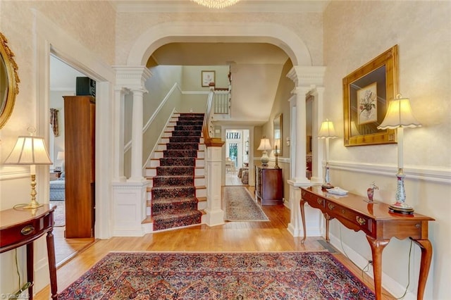 entrance foyer featuring crown molding and light hardwood / wood-style flooring