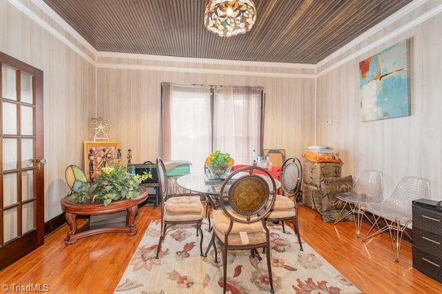 dining area with hardwood / wood-style floors and ornamental molding