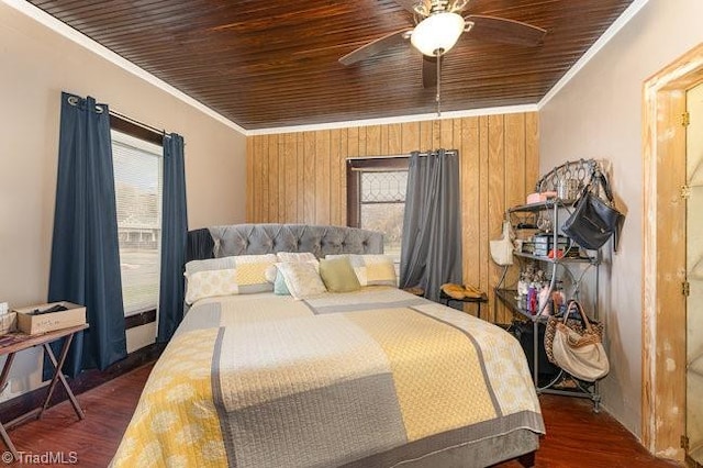 bedroom featuring ceiling fan, dark hardwood / wood-style flooring, wooden ceiling, and ornamental molding