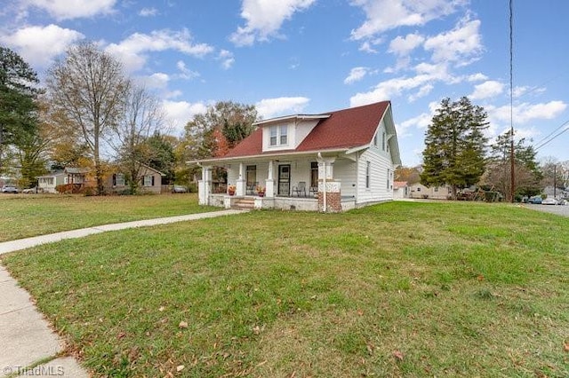 view of front of property with covered porch and a front lawn