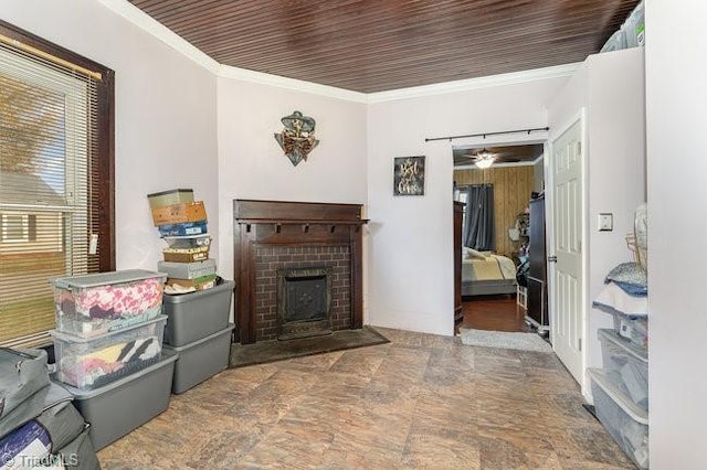 living room featuring a fireplace, ceiling fan, ornamental molding, and wood ceiling