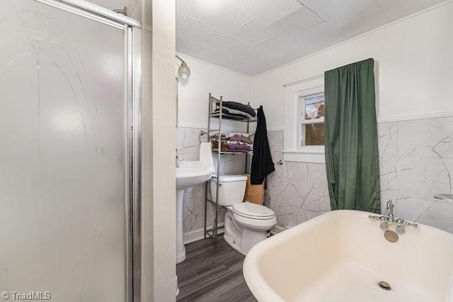 bathroom featuring hardwood / wood-style flooring, toilet, tile walls, and plus walk in shower