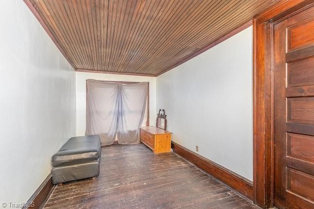 interior space with dark hardwood / wood-style flooring, crown molding, and wood ceiling