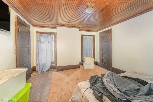 bedroom with hardwood / wood-style flooring, wood ceiling, and ornamental molding