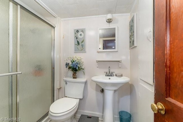 bathroom with toilet, walk in shower, and sink