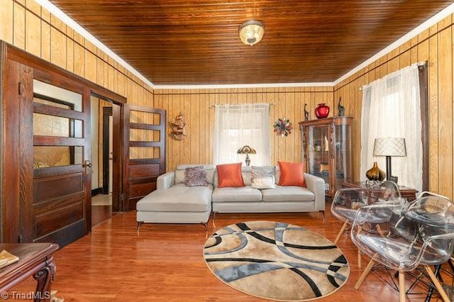 living area featuring wooden ceiling, wooden walls, hardwood / wood-style flooring, and a healthy amount of sunlight