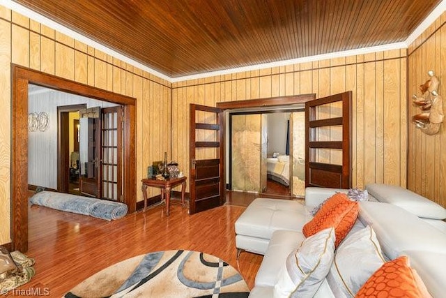 sitting room featuring hardwood / wood-style floors and wooden walls