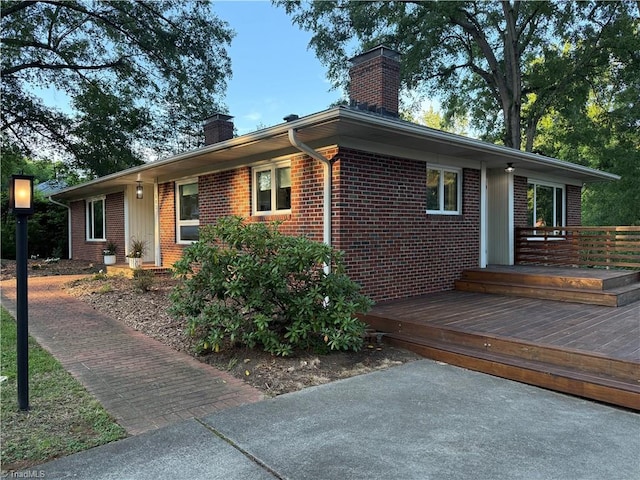 503 Tarleton Ave, Burlington, NC 27215 - single story home with a chimney, brick siding, and a wooden deck