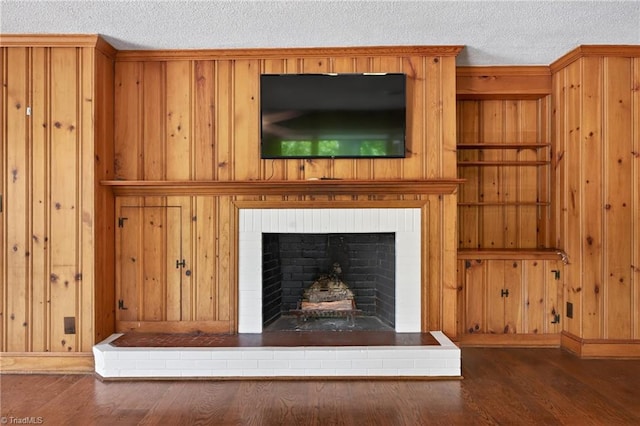 503 Tarleton Ave, Burlington, NC 27215 - detailed view of wood finished floors, a textured ceiling, wooden walls, and a fireplace