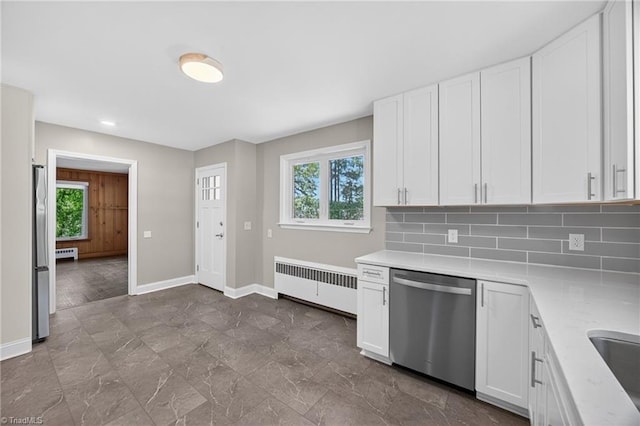 503 Tarleton Ave, Burlington, NC 27215 - kitchen featuring stainless steel appliances, radiator heating unit, light countertops, white cabinetry, and tasteful backsplash