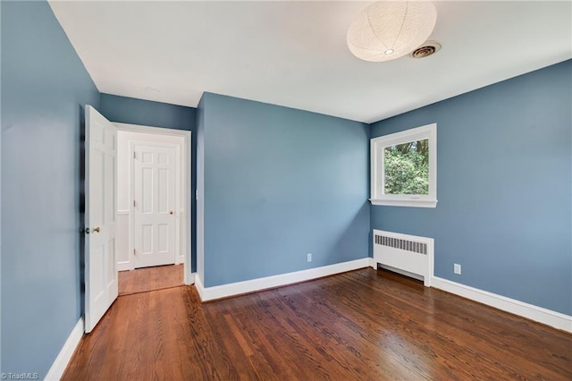 503 Tarleton Ave, Burlington, NC 27215 - empty room with radiator and wood finished floors