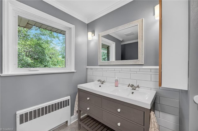 503 Tarleton Ave, Burlington, NC 27215 - bathroom featuring radiator heating unit, double vanity, crown molding, and decorative backsplash