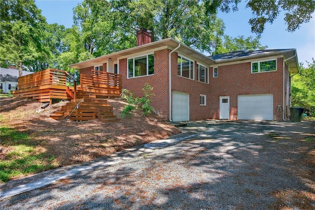 503 Tarleton Ave, Burlington, NC 27215 - view of side of property with a garage, a chimney, brick siding, and driveway