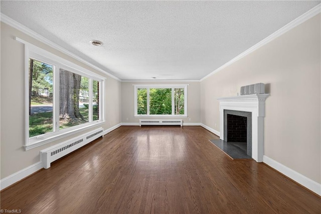 503 Tarleton Ave, Burlington, NC 27215 - unfurnished living room with dark wood finished floors, a baseboard heating unit, ornamental molding, a fireplace, and a textured ceiling