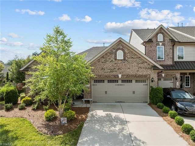 653 Piedmont Crossing Dr, High Point, NC 27265 - view of front of house with brick siding, concrete driveway, an attached garage, and roof with shingles