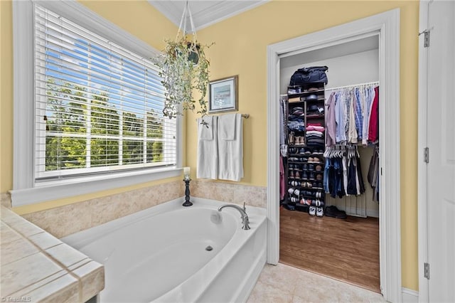 653 Piedmont Crossing Dr, High Point, NC 27265 - bathroom featuring crown molding, a garden tub, and a spacious closet