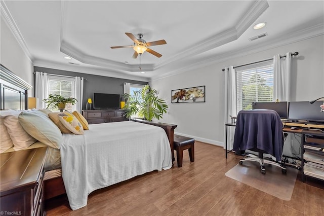 653 Piedmont Crossing Dr, High Point, NC 27265 - bedroom with a tray ceiling, crown molding, multiple windows, wood finished floors, and recessed lighting