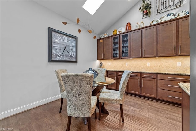 653 Piedmont Crossing Dr, High Point, NC 27265 - dining area with a skylight, vaulted ceiling, and light wood finished floors