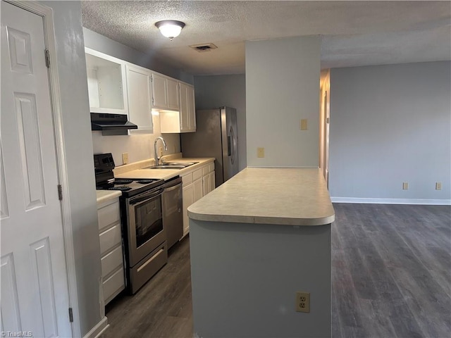 kitchen with appliances with stainless steel finishes, sink, white cabinetry, a textured ceiling, and dark wood-type flooring