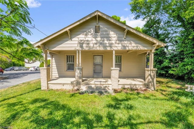 1821 Johnson St, High Point, NC 27262 - rear view of property featuring a porch and a yard