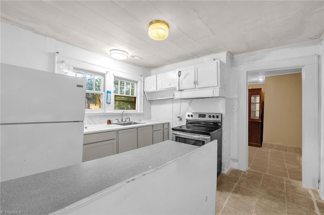 1821 Johnson St, High Point, NC 27262 - kitchen featuring stainless steel range with electric cooktop, a sink, gray cabinetry, freestanding refrigerator, and under cabinet range hood