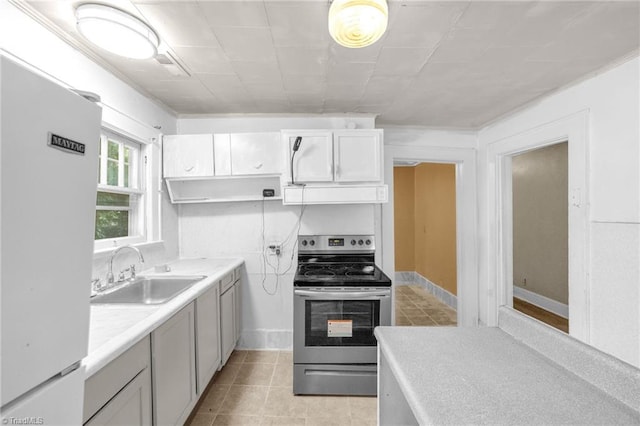 1821 Johnson St, High Point, NC 27262 - kitchen featuring a sink, light tile patterned floors, freestanding refrigerator, and stainless steel range with electric cooktop