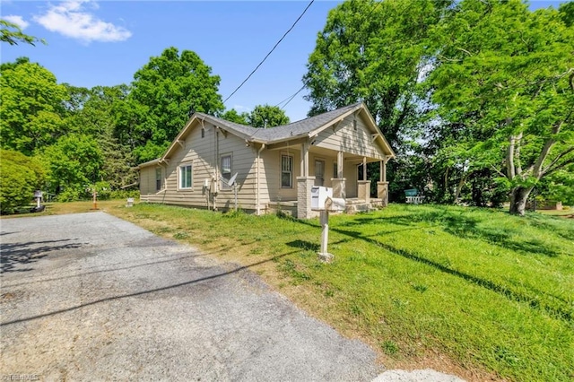 1821 Johnson St, High Point, NC 27262 - view of property exterior with a porch, aphalt driveway, and a lawn