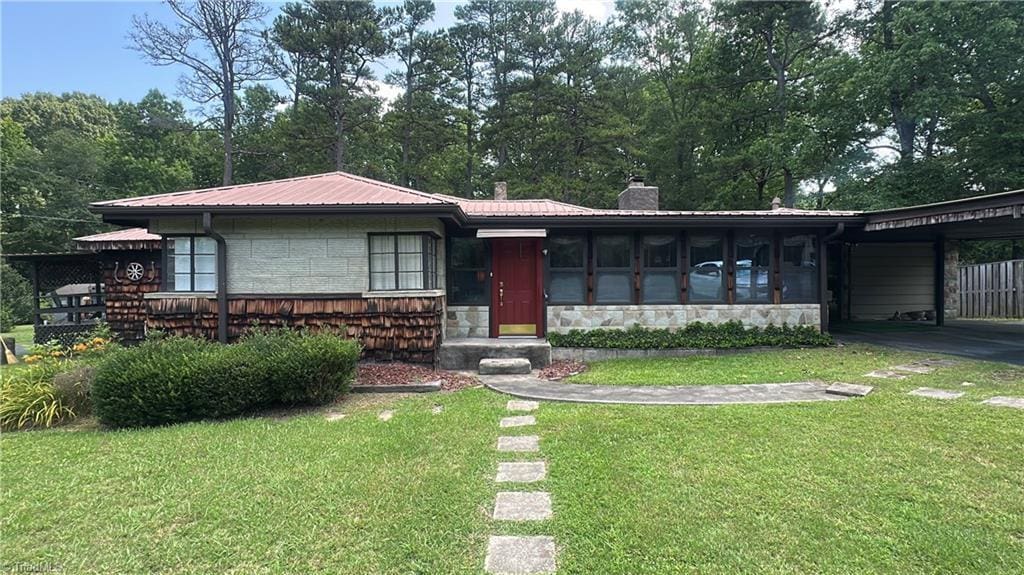 113 Ridgeway Dr, Thomasville, NC 27360 - view of front of property featuring stone siding, a chimney, a carport, a front yard, and a metal roof
