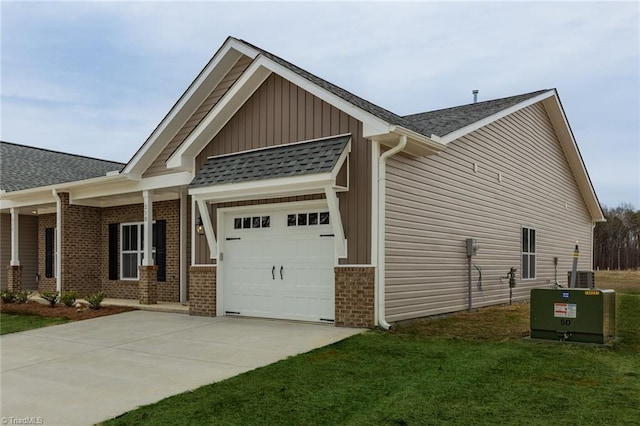 view of home's exterior with brick siding, an attached garage, board and batten siding, and concrete driveway
