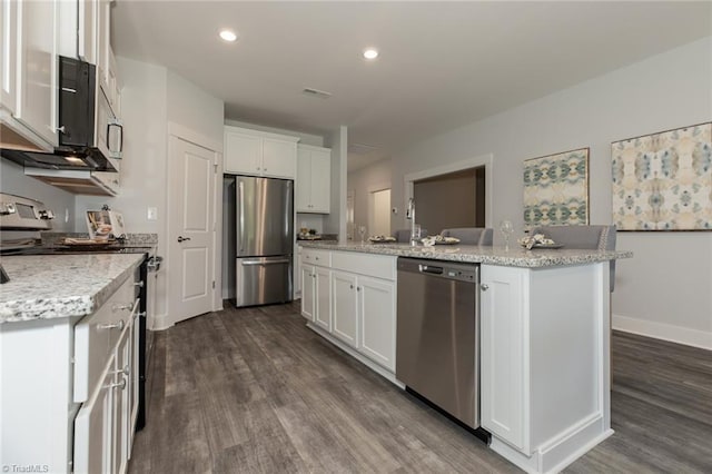 kitchen with white cabinetry, stainless steel appliances, dark wood finished floors, a center island with sink, and visible vents
