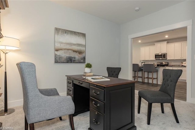 office space with baseboards and recessed lighting