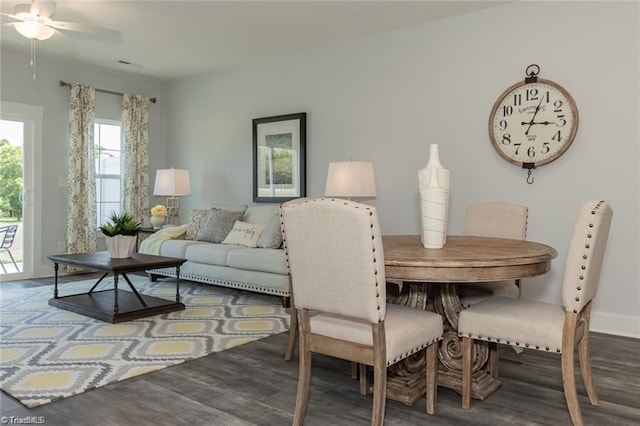 dining room with baseboards, wood finished floors, and a ceiling fan