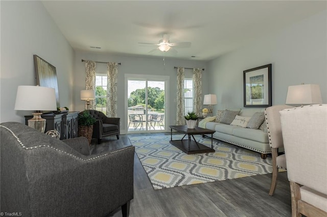 living room with wood finished floors and ceiling fan