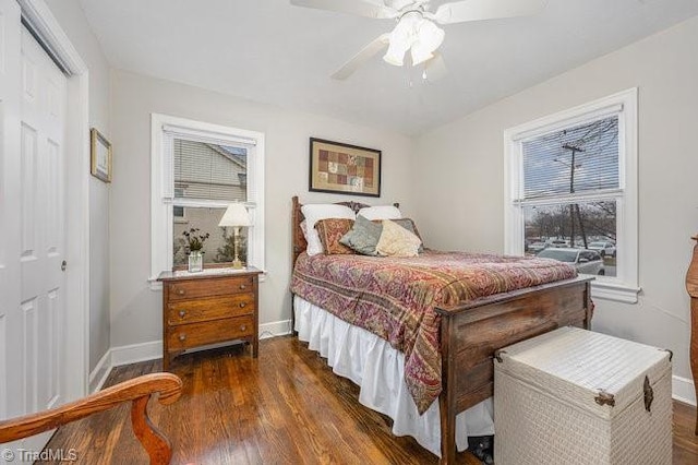 bedroom with ceiling fan, dark hardwood / wood-style floors, and a closet