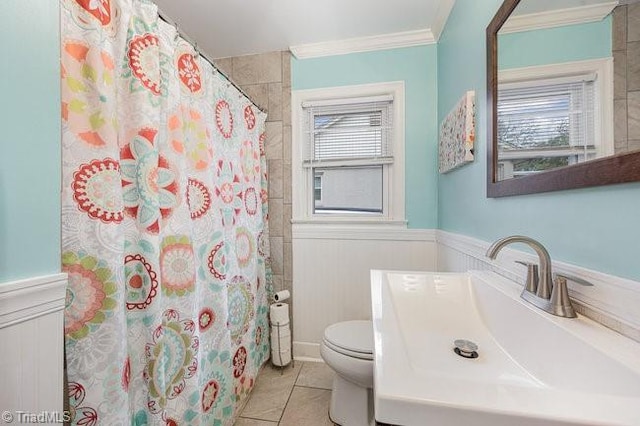 bathroom with tile patterned flooring, vanity, toilet, crown molding, and a shower with shower curtain