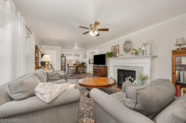 living room featuring ornamental molding and ceiling fan