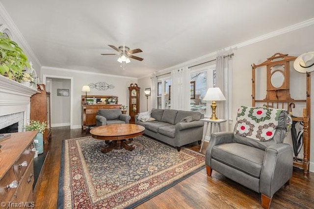 living room with dark wood-type flooring, ceiling fan, and ornamental molding