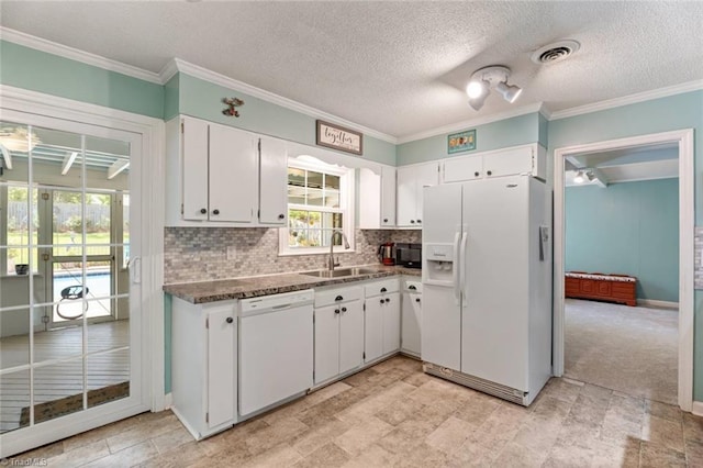 kitchen featuring white appliances, a sink, white cabinets, decorative backsplash, and ornamental molding