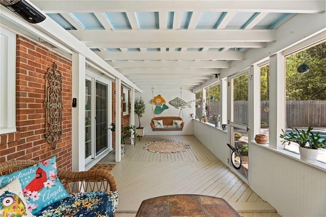 sunroom / solarium featuring healthy amount of natural light