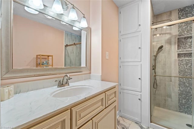 full bathroom with a shower stall, vanity, and marble look tiles