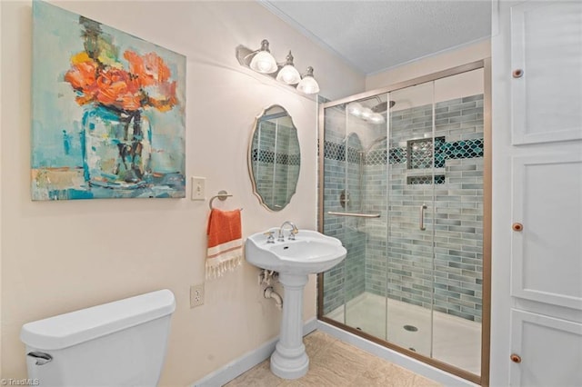 full bathroom featuring a shower stall, toilet, baseboards, a textured ceiling, and tile patterned flooring