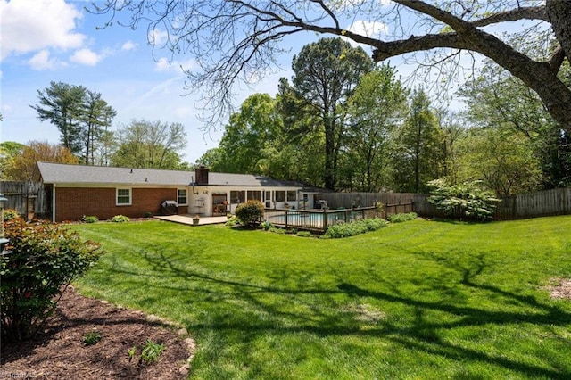 back of house with brick siding and a chimney