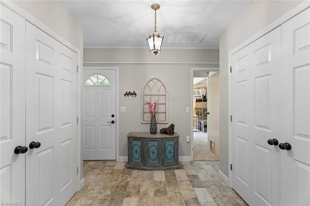 foyer featuring baseboards and stone finish flooring