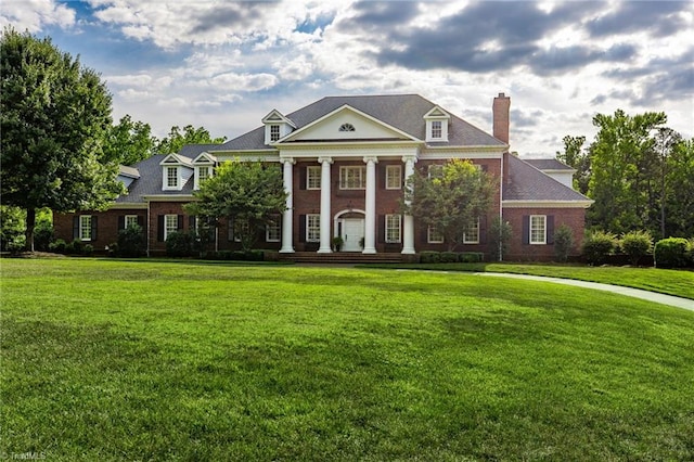 greek revival house featuring a front lawn