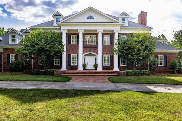 greek revival house with a front lawn